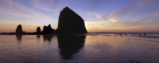 Beachcombers Near Haystack Rock at sunset; location for the film: The Goonies